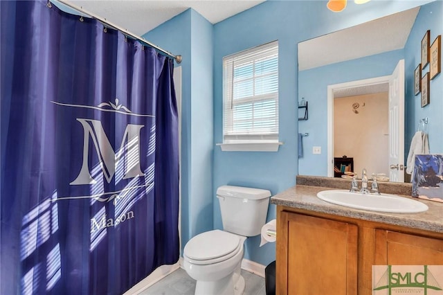 bathroom featuring toilet and vanity