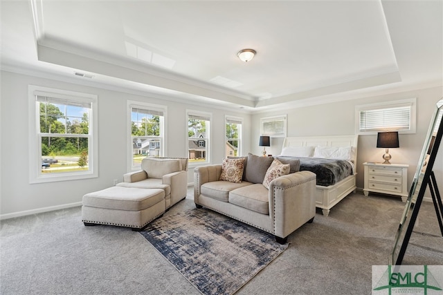 bedroom featuring carpet floors, a tray ceiling, and crown molding