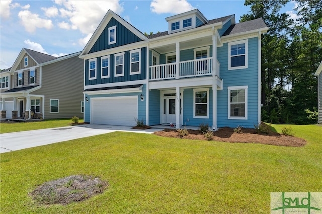 view of front of house featuring a garage, a balcony, and a front yard