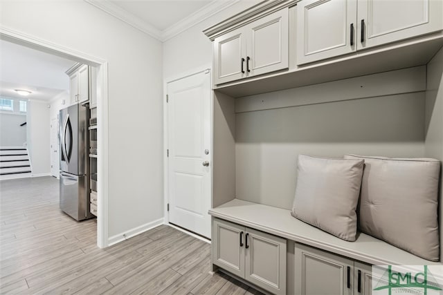 mudroom with crown molding and light hardwood / wood-style flooring