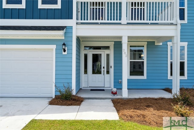 entrance to property featuring a balcony and a garage