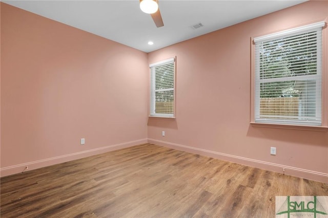 spare room featuring hardwood / wood-style flooring and ceiling fan