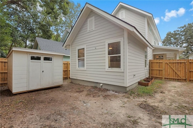 back of property with a storage unit