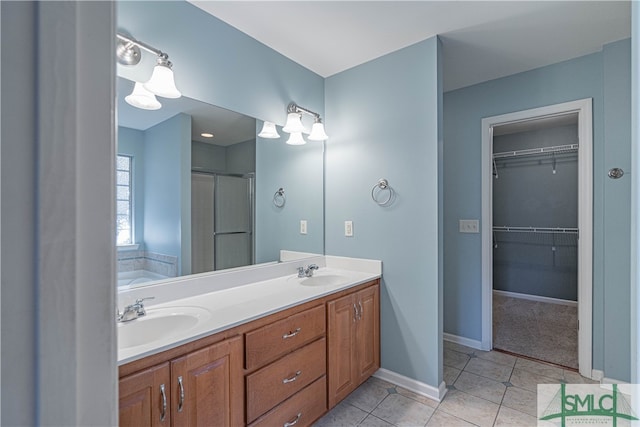 bathroom featuring tile patterned flooring, vanity, and plus walk in shower