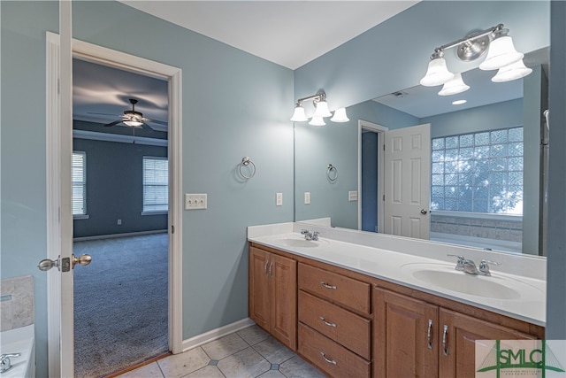 bathroom with a bathing tub, ceiling fan, tile patterned flooring, and vanity