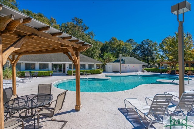 view of swimming pool featuring a patio area