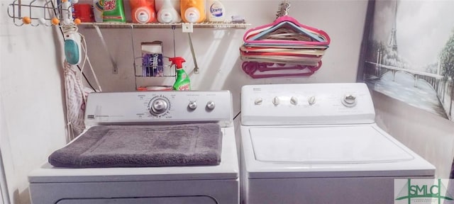 clothes washing area featuring washer and clothes dryer