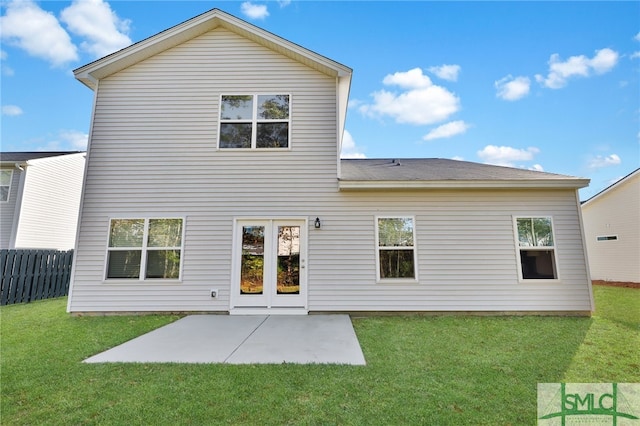 rear view of property with a lawn and a patio area