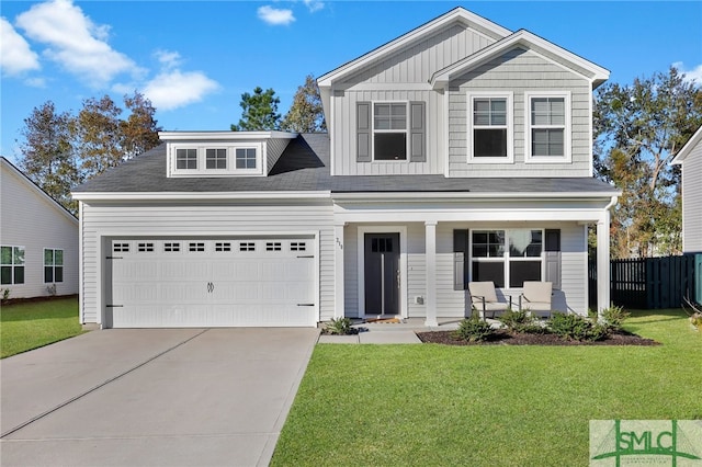 view of front facade featuring covered porch, a garage, and a front lawn