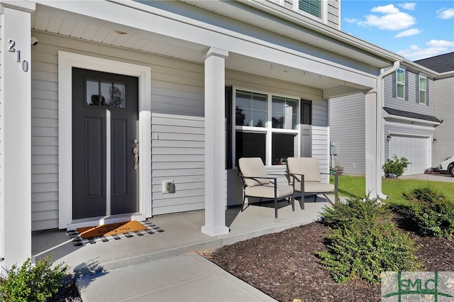 property entrance featuring a porch and a garage