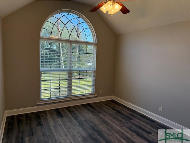 spare room with ceiling fan, lofted ceiling, a healthy amount of sunlight, and dark hardwood / wood-style flooring