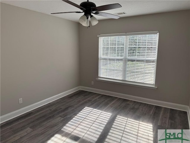 spare room with dark wood-type flooring and ceiling fan