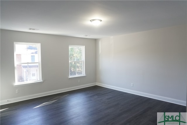 spare room with dark hardwood / wood-style flooring