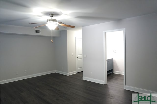 spare room featuring ceiling fan and dark hardwood / wood-style flooring