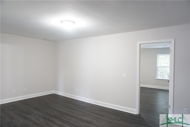 unfurnished room featuring dark hardwood / wood-style floors