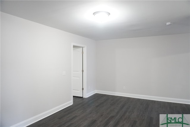 unfurnished room featuring dark wood-type flooring