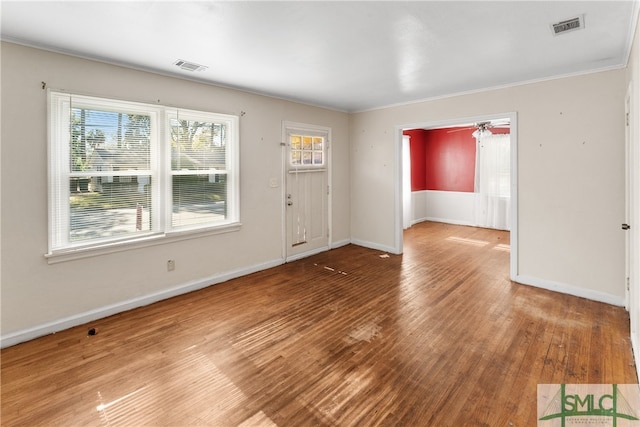 entryway featuring crown molding, plenty of natural light, and hardwood / wood-style floors