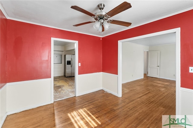 spare room with ceiling fan, ornamental molding, and hardwood / wood-style flooring