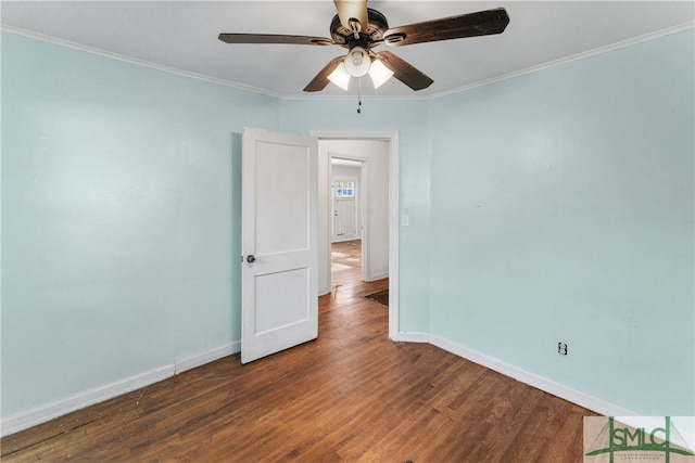 empty room featuring ceiling fan, dark hardwood / wood-style floors, and ornamental molding