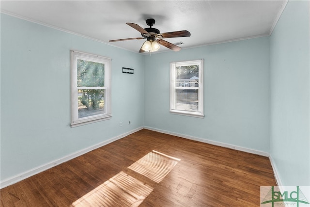 spare room with wood-type flooring, ceiling fan, and crown molding