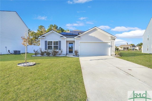 ranch-style house with a front yard, solar panels, a garage, and central AC unit