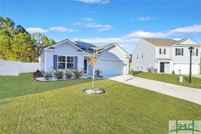 view of front facade featuring a front yard, solar panels, and a garage