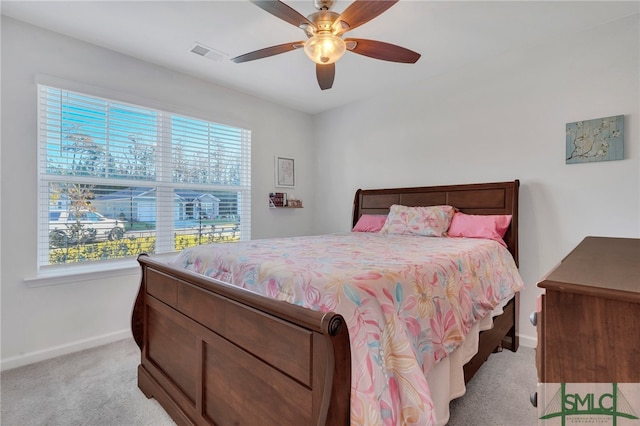 carpeted bedroom featuring ceiling fan and multiple windows