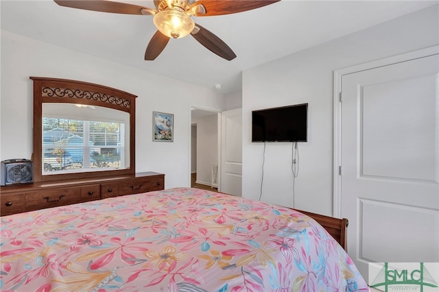 bedroom with ceiling fan and a closet