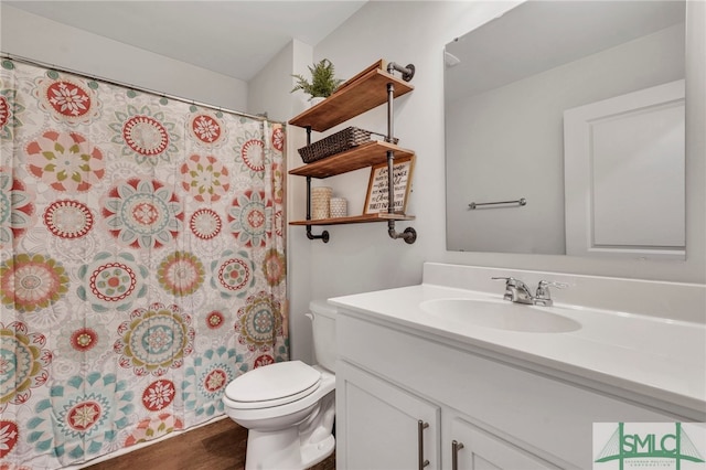 bathroom with a shower with curtain, hardwood / wood-style floors, vanity, and toilet