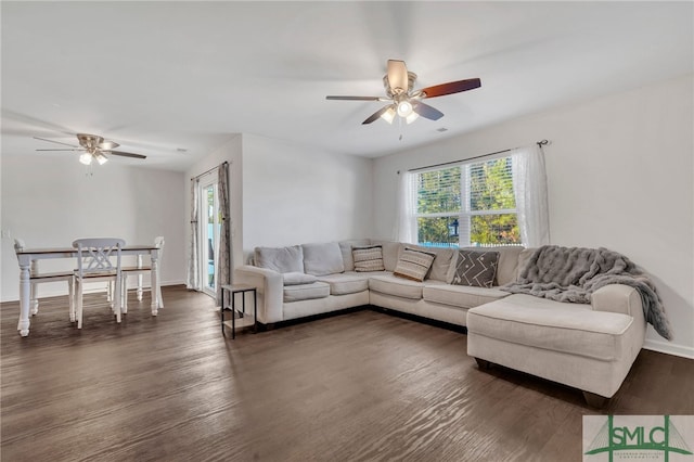 living room with dark hardwood / wood-style floors and ceiling fan