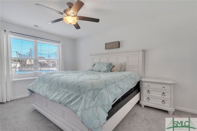 bedroom featuring ceiling fan and light carpet