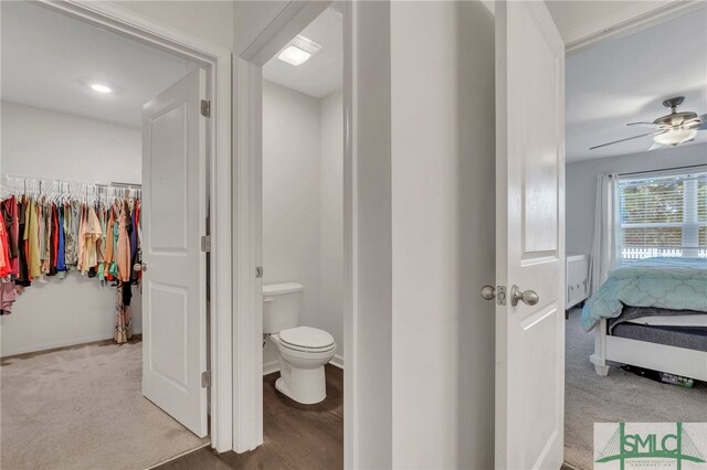 bathroom featuring ceiling fan and toilet