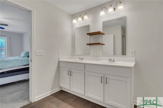 bathroom featuring ceiling fan, wood-type flooring, and vanity