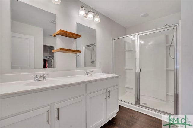 bathroom featuring hardwood / wood-style floors, vanity, and walk in shower