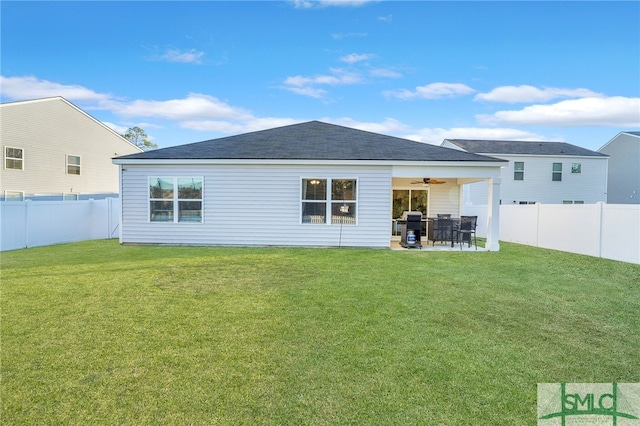 back of house with a lawn, ceiling fan, and a patio