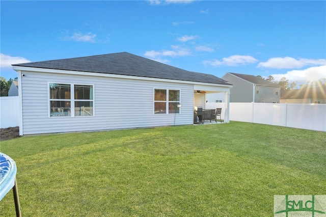 back of property featuring a patio area and a lawn