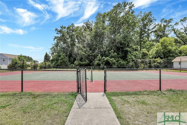 view of sport court featuring a lawn