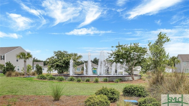 view of property's community with a lawn