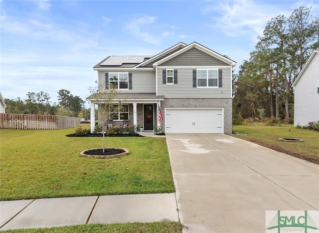 view of front of house with a front yard, solar panels, and a garage