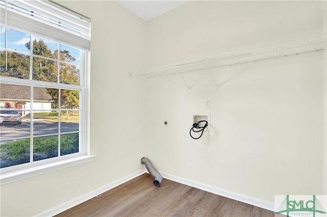 washroom featuring electric dryer hookup, a healthy amount of sunlight, wood-type flooring, and hookup for a washing machine