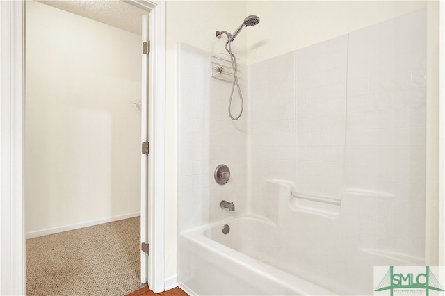 bathroom featuring shower / washtub combination and a textured ceiling