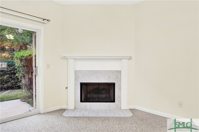 interior details featuring carpet flooring and a tiled fireplace