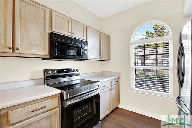 kitchen featuring dark hardwood / wood-style flooring, light brown cabinetry, and appliances with stainless steel finishes