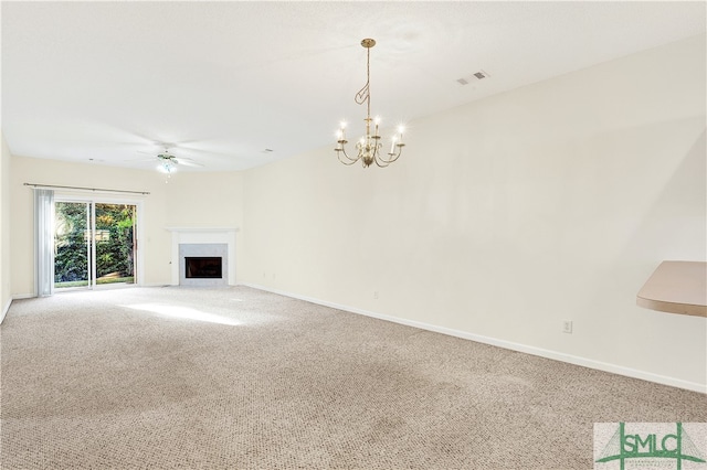 unfurnished living room featuring carpet flooring and ceiling fan with notable chandelier