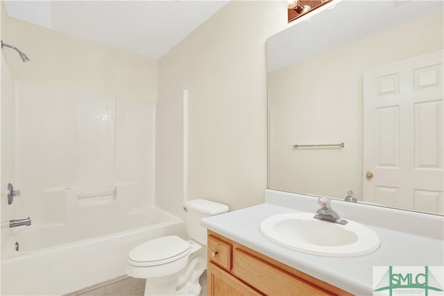 full bathroom featuring toilet, vanity, a textured ceiling, and bathtub / shower combination