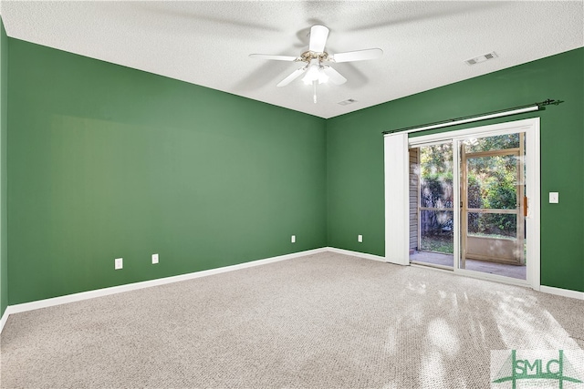 unfurnished room featuring ceiling fan, carpet, and a textured ceiling