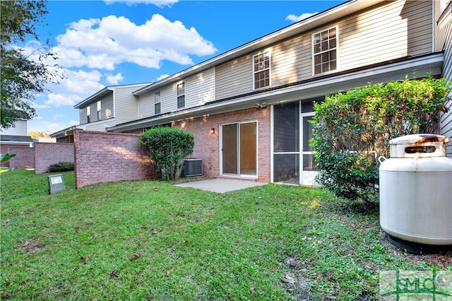 back of house with a lawn and central AC unit