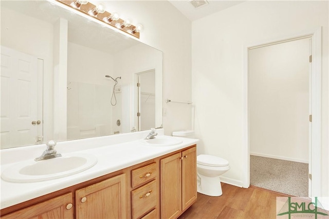 2 Putters Pl, Savannah, GA 31419 - bathroom with double vanity, a shower, wood finished floors, and toilet