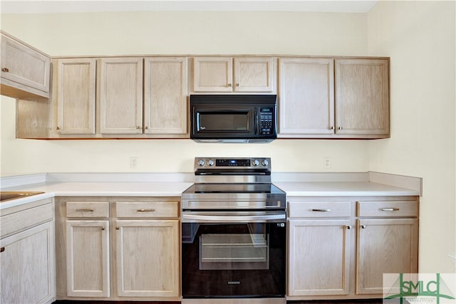 kitchen with light brown cabinets and stainless steel range with electric cooktop