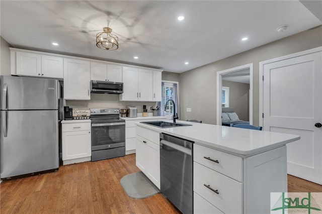 kitchen with sink, stainless steel appliances, light hardwood / wood-style flooring, an island with sink, and white cabinets